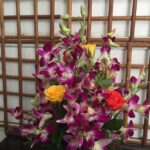 Orchids and roses glass vase