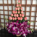 21 roses and orchids in a basket